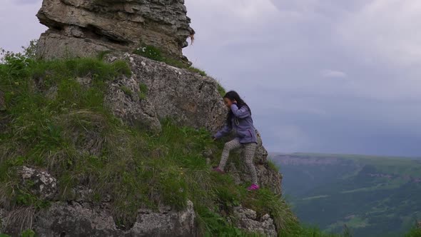 Girl Goes to the Edge of a Cliff and Opens Her Arms