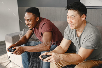 playing Playstation. Friends play game in a free time with a joystick.