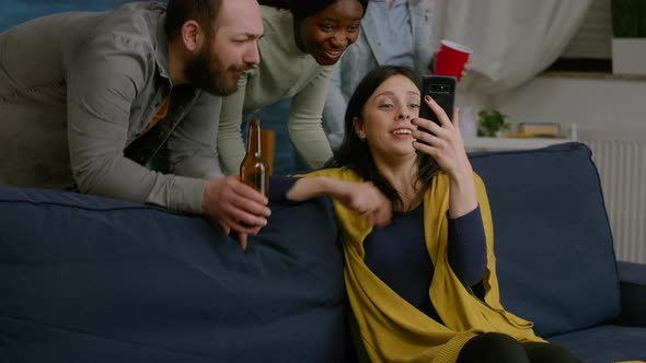 Group of Mixed Race People Spending Time Together While Looking at Comedy Video