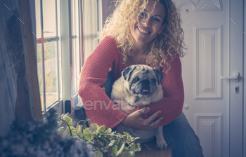 Woman and dog home portrait sitting together hugging and enjoying friendship together / Photodune, Misc