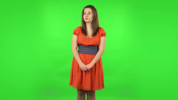 Cute Girl Examines Something Then Fearfully Covers Her Face with Her Hands. Green Screen