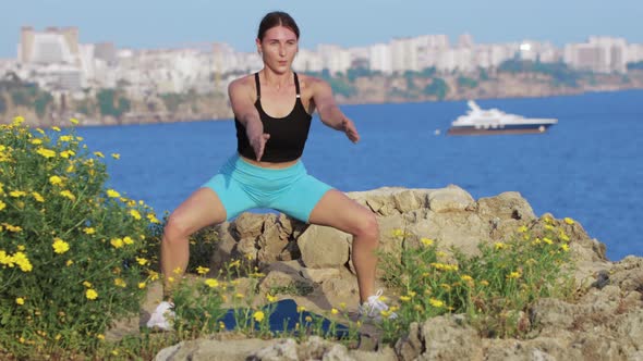 Sports Outdoors  a Woman Doing Exercises on Yoga Mat By the Sea