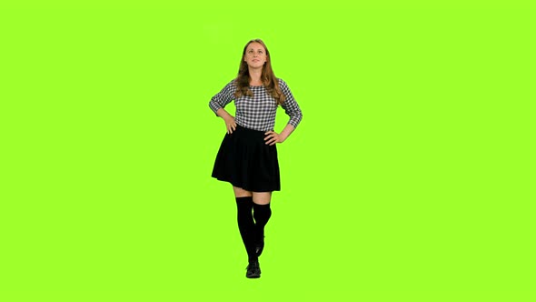 Cheerful Female Walking with Hands on Hips against Green Background, Chroma Key