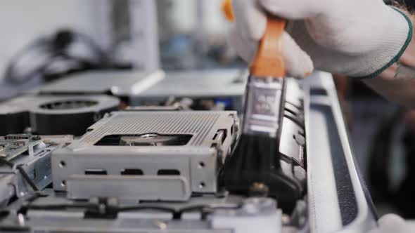 Closeup Shot of Male Hands Working on Disassembling and Cleaning Circuit Board in Laptop Using Brush