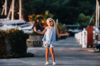 Cute girl near the yachts in the summer. Travel, adventure, boat trips with a child for a family / Photodune, Misc