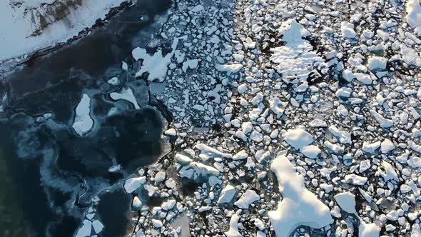 Severe icy river with rough snowy shores