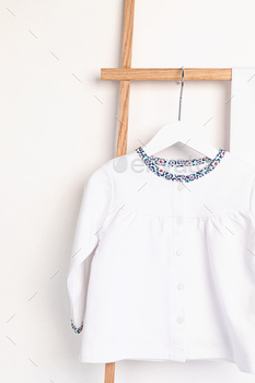 Cute newborn clothes hanging on the rack / Photodune, Misc