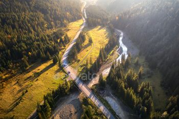 Aerial view of mountain road and beautiful forest at sunset / Photodune, Misc