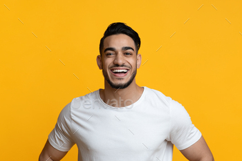 Closeup portrait of cheerful arab guy laughing at camera / Photodune, Misc