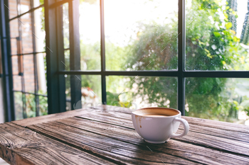 A white mug of hot coffee on wooden table in the morning / Photodune, Misc