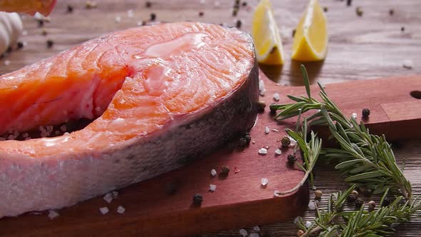 Raw, Fresh Salmon Steak on a Slate Board and Spices Around. Healthy Food Concept