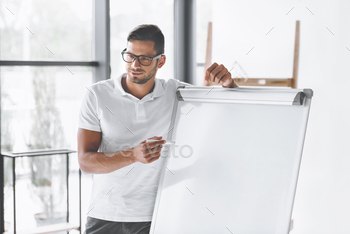 smiling businessman making presentation at white board in office / Photodune, Misc