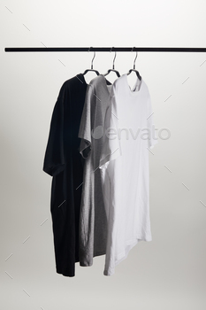 black, grey and white shirts on hangers isolated on white / Photodune, Misc