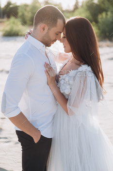 tender couple with closed eyes hugging on beach / Photodune, Misc