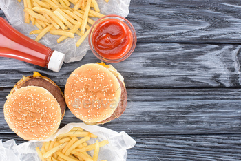 top view of hamburgers with french fries and ketchup on wooden table / Photodune, Misc