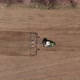 Aerial Top View of Tractor Cutting Furrows in Farm Field for Sowing Farm Tractor with Rotary Harrow - VideoHive Item for Sale