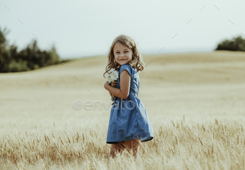 A little girl in a wheat field. Fall season theme / Photodune, Misc