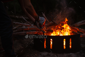 Close Up  of Man Hands Working in a Fire Pit in a Camping at Night.Outdoor Concept / Photodune, Misc