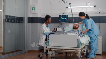 Afro american practitioner monitoring sick man analyzing sickness symptom / Photodune, Misc