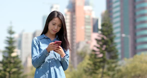 Young woman use of mobile phone in city