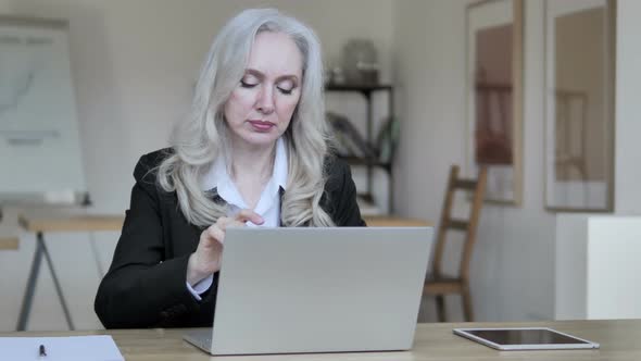 Old Business Woman Thinking and Working on Laptop