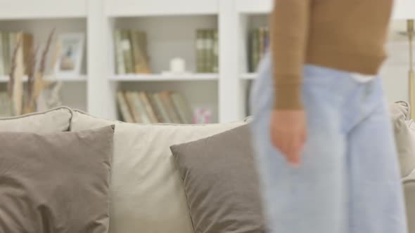 Young African Woman Standing and Going Away on Sofa