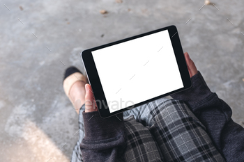 A woman holding and using black tablet pc with blank white desktop screen / Photodune, Misc