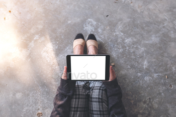 A woman holding and using black tablet pc with blank white desktop screen / Photodune, Misc