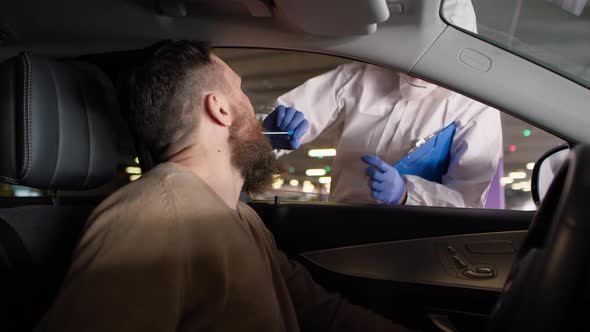 Video of driver during coronavirus drive-thru PCR test procedure. Shot with RED helium camera in 8K.