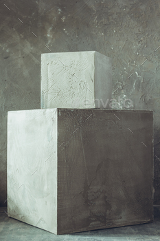Concrete cube or cement brick near wall background. Construction block on floor / Photodune, Misc