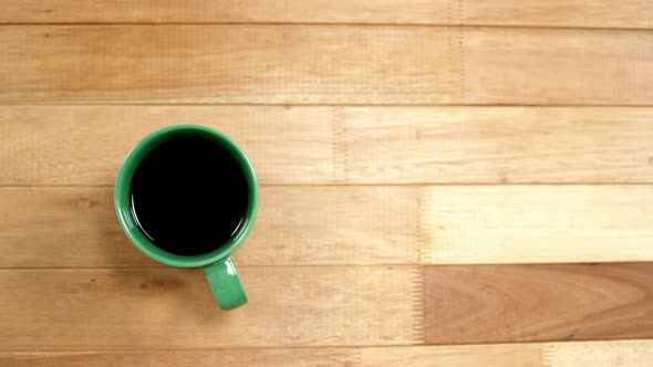 Close-up of green coffee cup