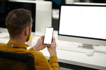 Male manager using phone in IT office / Photodune, Misc