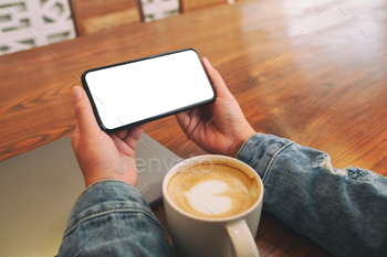 Hands holding black mobile phone with blank desktop screen horizontally / Photodune, Misc