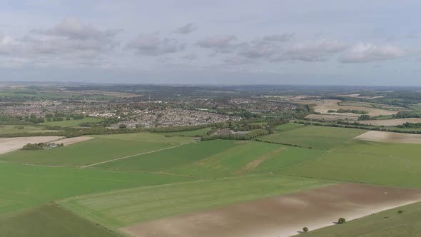 Aerial tracking forward towards the historic town of Dorchester from the south. Old Roman town, with