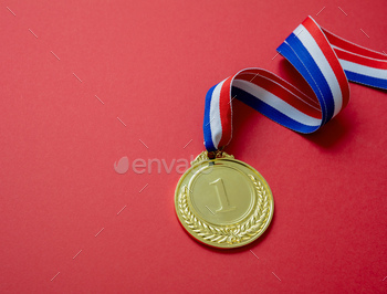Gold medal. Champion trophy award and ribbon. Prize in sport for winner isolated on red background / Photodune, Misc