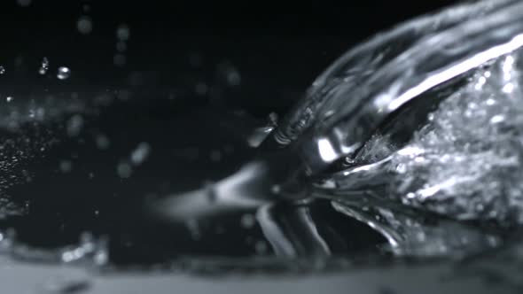 Water splash on black surface, Slow Motion