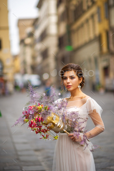 a bride in a wedding dress with a Venetian mask in her hands in Florence.Italy / Photodune, Misc