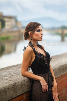 Beautiful stylish bride in a black dress stands on the embankment in Florence, Italy / Photodune, Misc