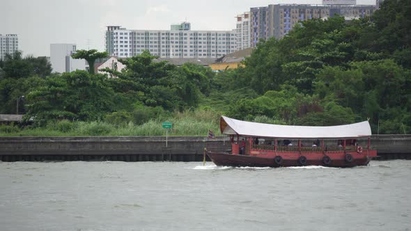 Traditional thai long-tail boat run along the river with network of river trams and taxi