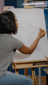 Young african american artist creating vase design on canvas / Photodune, Misc