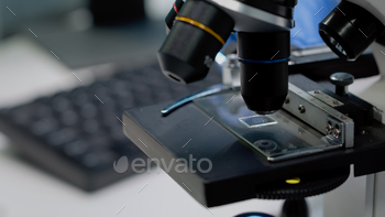 Close up of glass tray on microscope for examination / Photodune, Misc