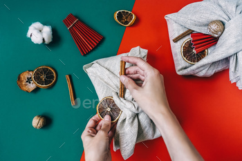 Woman hands wrapping Furoshiki gifts. Zero waste. / Photodune, Misc