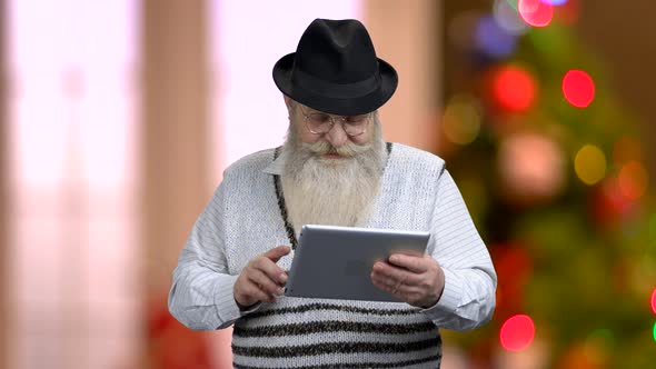 Senior Man Talking Via Internet with Relatives.