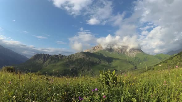 View of the mountain valley and dolomite rocks in the clouds.