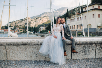 Italy, Lake Garda. A beautiful couple on the shores of lake Garda in Italy at the foot of the Alps.A / Photodune, Misc