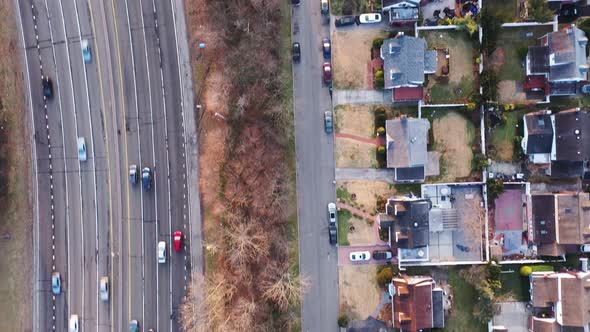 A top down view over a suburban neighborhood in the early morning. The streets below are quiet and t