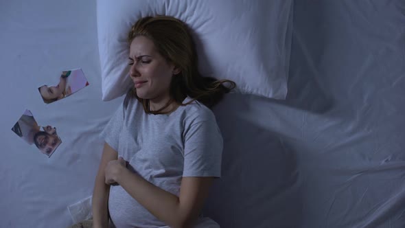 Depressed Mother-To-Be Crying in Bed, Looking at Torn Photo, Break-Up Divorce