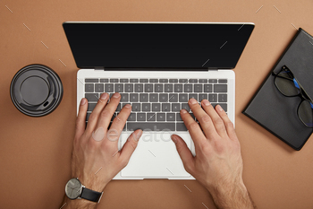 cropped view of businessman typing on laptop at workplace / Photodune, Misc