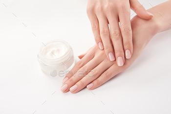 Partial view of woman applying cosmetic cream on white background / Photodune, Misc