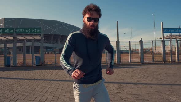 Portrait Hipster Male Dancing in Street Looking To Camera